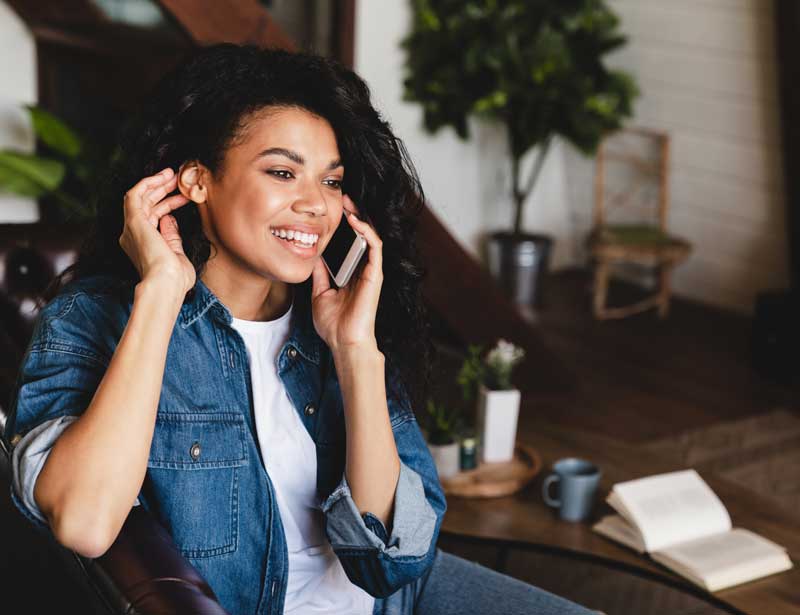 UtilityShield Customer, woman on the phone smiling